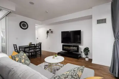 a living room with a couch and a table at Urban Lifestyle 1BR Suite w CN Tower and Lake view in Toronto