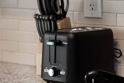 a toaster oven sitting on a counter next to a cutting board at Urban Lifestyle 1BR Suite w CN Tower and Lake view in Toronto