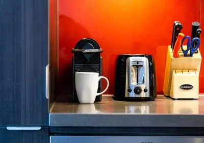 a counter with a coffee maker and a cup on it at Welcoming Downtown Condo with WFH setup Balcony in Toronto