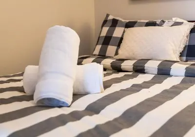 a bed with rolled up sheets and pillows on it at Welcoming Downtown Condo with WFH setup Balcony in Toronto