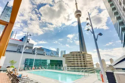 a pool on a cruise ship with the cn tower in the background at Welcoming Downtown Condo with WFH setup Balcony in Toronto