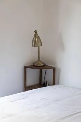 a bed with a lamp on a side table at 3BR Rooftop Pool Gym Steps to MTCC and CN Tower with Parking in Toronto