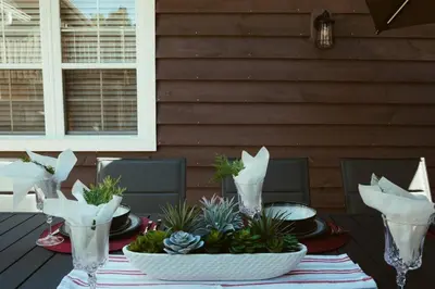 a table with plants in bowls on a patio at Beach House 5 Star Gem with a Muskoka room and Yoga Studio in Innisfil