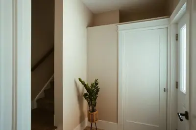 a hallway with a plant in a vase next to a door at Beach House 5 Star Gem with a Muskoka room and Yoga Studio in Innisfil