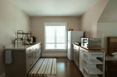 a kitchen with a white refrigerator and a window at Beach House 5 Star Gem with a Muskoka room and Yoga Studio in Innisfil