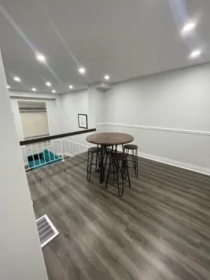 a room with a table and chairs in it at Triple M Lodge Double in Mississauga