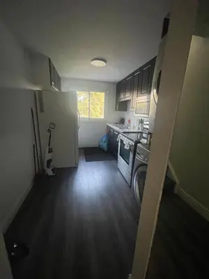 a small kitchen with a washer and dryer in it at Triple M Lodge Double in Mississauga