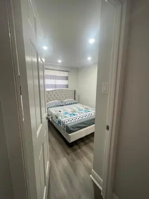 a small bedroom with a bed in a room at Triple M Lodge Double in Mississauga