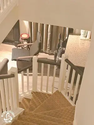 a staircase with chairs and a table in a room at Blue Mountain, Collingwood - Loft Condo, sleeps 4 in Blue Mountains