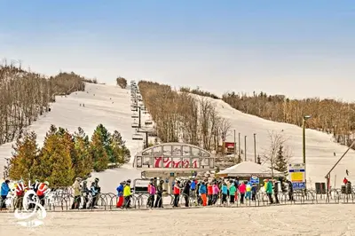 a group of people standing in front of a ski slope at Blue Mountain, Collingwood - Loft Condo, sleeps 4 in Blue Mountains