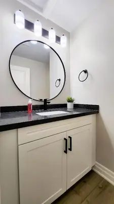 a bathroom with a sink and a mirror at The Zen Escape Modern Queen Size One Bedroom Full Apartment in St. Catharines