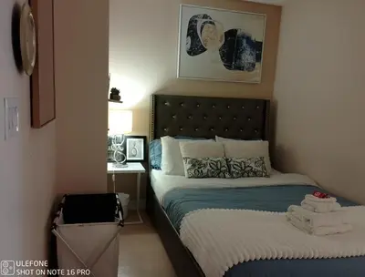 a small bedroom with a bed and a desk at Downtown Toronto Condo Suite in Toronto
