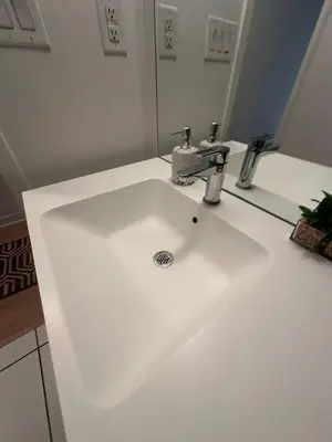 a white sink in a bathroom with a mirror at Downtown Toronto Condo Suite in Toronto