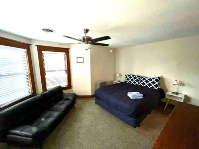 a living room with a bed and a couch at Vintage cute house 5 min from the beautiful Falls! in Niagara Falls