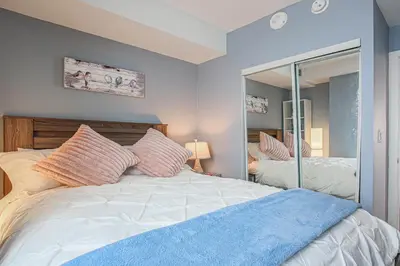 a bedroom with a large bed and a mirror at Luxury view in Toronto Downtown 3 Bedroom 2.5 Bathroom 1 Parking in Toronto