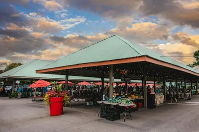 a farmers market with a green roof with people in it at Holiday Inn Express & Suites St Thomas in Saint Thomas