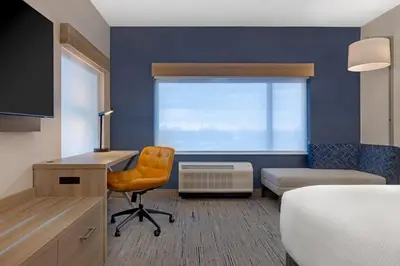a room with a desk and a bed and a window at Holiday Inn Express & Suites St Thomas in Saint Thomas