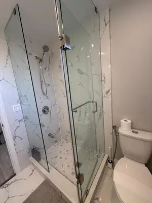 a bathroom with a glass shower with a toilet at Family-Friendly 3BR in Little Italy in Toronto