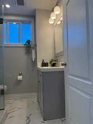 a bathroom with a sink and a mirror at Family-Friendly 3BR in Little Italy in Toronto
