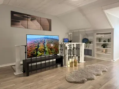a living room with a flat screen tv on a wall at Family-Friendly 3BR in Little Italy in Toronto