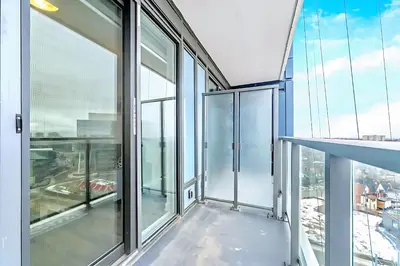 an empty balcony of a building with glass windows at Luxurious 1BR Condo - Stunning City Views in Kitchener