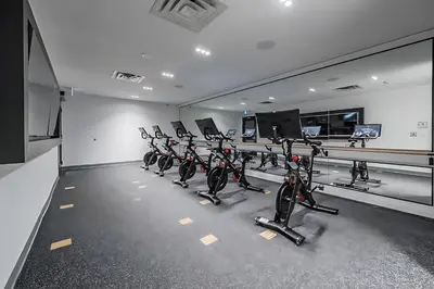 a row of exercise bikes in a gym at Luxurious 1BR Condo - Stunning City Views in Kitchener