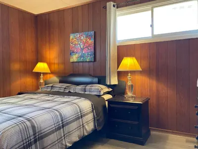 a bedroom with two beds and a window and two lamps at Lucky home- Vacation Houses in Trenton