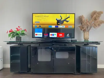 a tv sitting on top of a glass table at Lucky home- Vacation Houses in Trenton