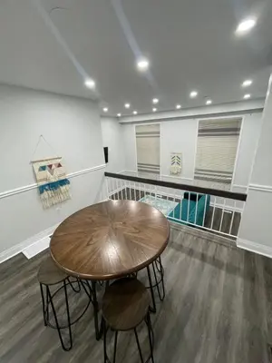 a room with a wooden table and two chairs at Mo's Place in Mississauga