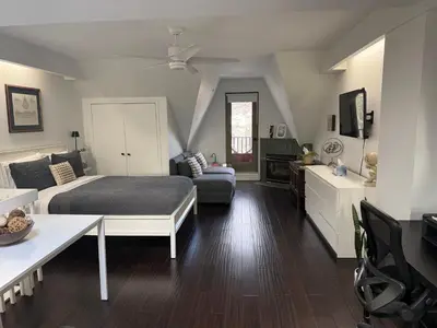 a bedroom with a bed and a living room at Bright, Private, Peaceful Suite with Retail Conveniences Steps Away in Toronto