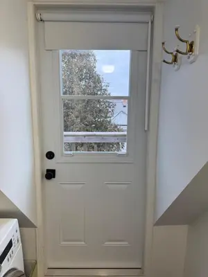 a white door with a window in a kitchen at Bright, Private, Peaceful Suite with Retail Conveniences Steps Away in Toronto