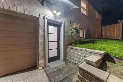 a door to a house with a grass yard at Modern 2BR on Queensway, Kitchen, Parking, 20 Mins from CNT and YYZ in Toronto