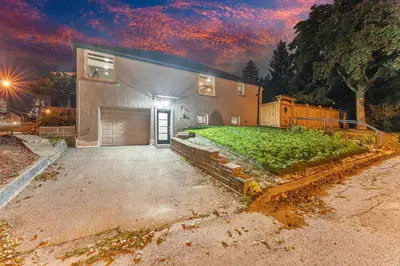 a building with a garage with a grass yard at Modern 2BR on Queensway, Kitchen, Parking, 20 Mins from CNT and YYZ in Toronto