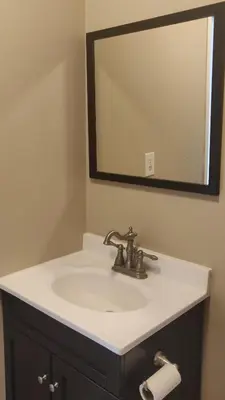 a bathroom with a sink and a mirror at The Comfort Stay at City of Pickering in Pickering