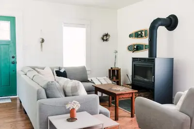 a living room with a couch and a fireplace at The Beachside Burrow - Next to Sandbanks w Hot Tub in West Lake