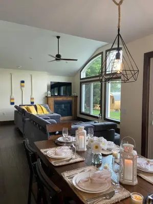 a dining room with a table and a couch at Four Season Waterfront Muskoka Retreat in Bracebridge