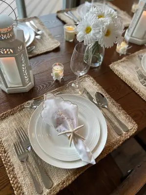 a table with a white plate with a starfish on it at Four Season Waterfront Muskoka Retreat in Bracebridge