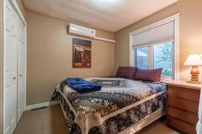 a small bedroom with a bed and a window at Waterfront - Kawartha Lakes in Kawartha Lakes