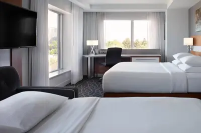 a hotel room with two beds and a desk at Delta Hotels by Marriott Waterloo in Waterloo