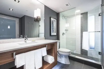 a bathroom with a sink and a toilet and a shower at Delta Hotels by Marriott Waterloo in Waterloo