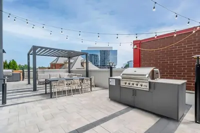 a patio with a grill and a table and chairs at Union Towers Condo with City Views and Patio in Kitchener