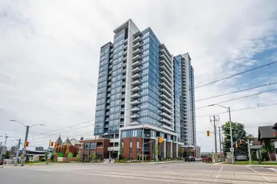 a tall building on the corner of a street at Union Towers Condo with City Views and Patio in Kitchener
