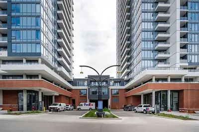 a parking lot in a city with tall buildings at Modern 1BR Condo - King bed - Cityscape Views in Kitchener