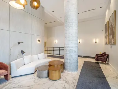 a living room with a white couch and a table at Modern 1BR Condo - King bed - Cityscape Views in Kitchener