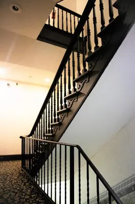 a black spiral staircase in a building with a ceiling at Royal Inn and Suites at Guelph in Guelph