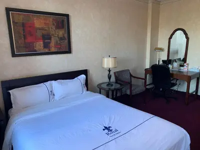 a hotel room with a bed and a desk at Royal Inn and Suites at Guelph in Guelph