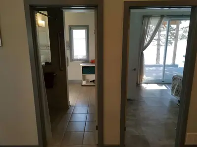 a hallway with a door open to a room with a kitchen at SkyTime Vacations in Wellington