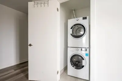 a washer and dryer in a laundry room at 1BR Modern Condo - King Bed and Stunning City View in Kitchener