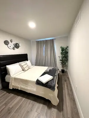 a bedroom with a large bed and a window at Stylish House W a Media Room Near Downtown Picton in Picton