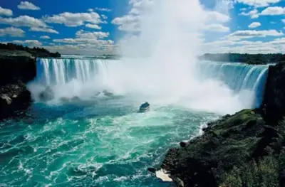 a view of a waterfall with water in the foreground at Stylish Townhome Gem with Several Amenities Just Minutes To The Falls in Niagara Falls